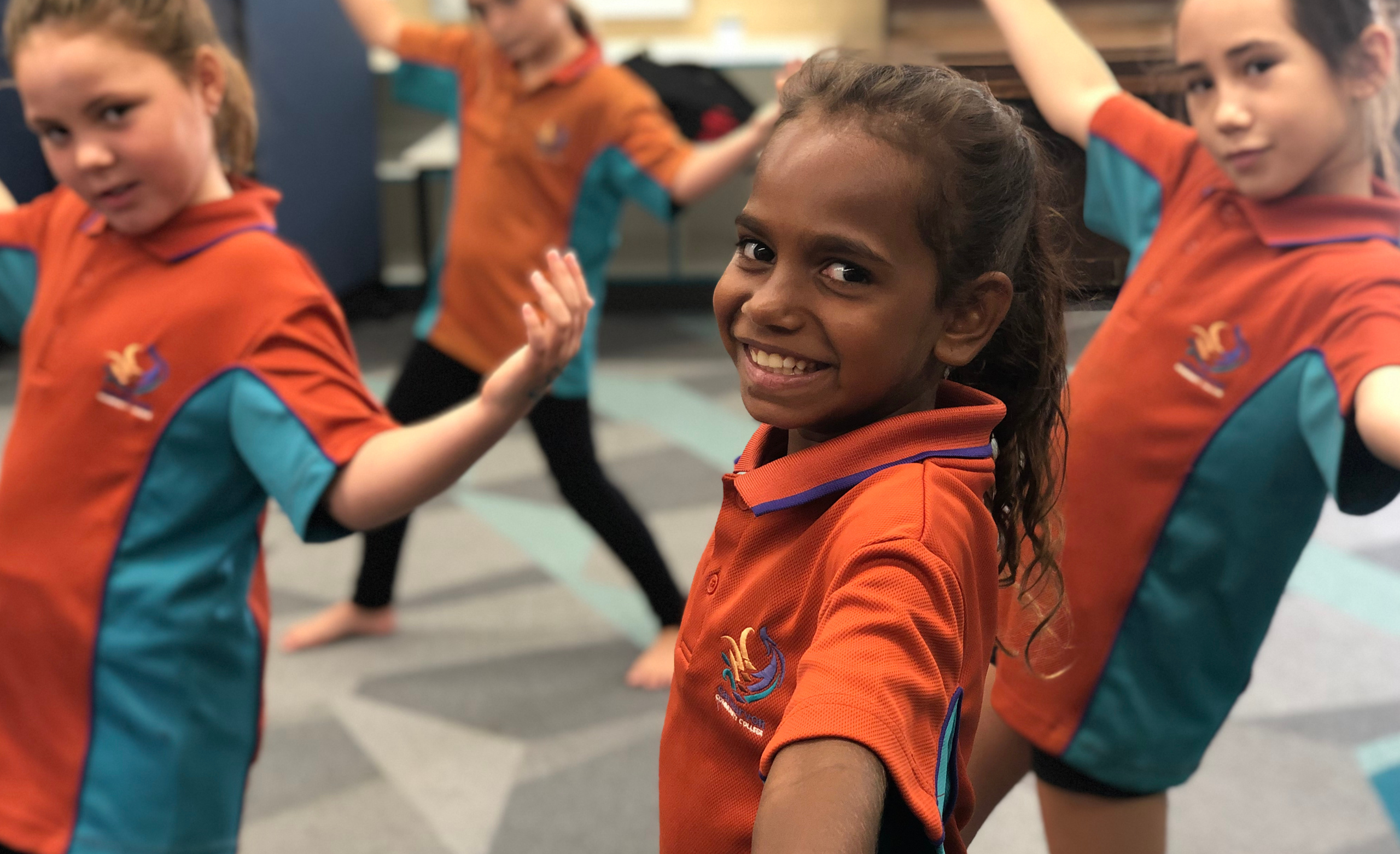 REDed students dance together during class