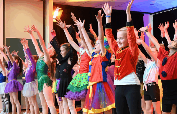 Children in costumes performing on stage